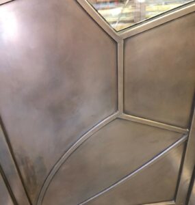 bronze panel separated by architectural bronze lites